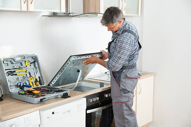 Professional servicing a stove